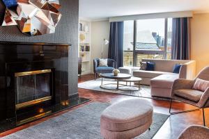 a living room with a fireplace and a couch at The Yorkville Royal Sonesta Hotel Toronto in Toronto