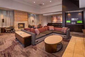 a living room with a couch and a fireplace at Sonesta Select Arlington Rosslyn in Arlington