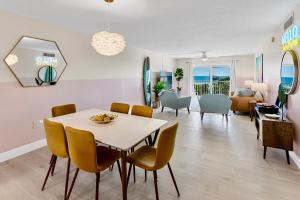 a dining room and living room with a table and chairs at Cocoa Beach Towers in Cocoa Beach