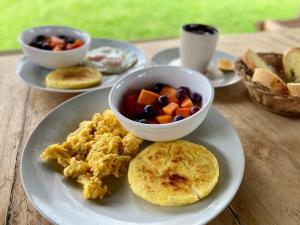 a plate of food with a bowl of fruit and vegetables at Posada Chaska in San Agustín