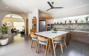 a kitchen with a table and chairs and a couch at Casa 88 Berawa in Canggu