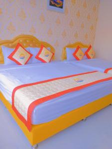 1 dormitorio con 1 cama grande y almohadas coloridas en Khách sạn Sunrise Ninh Thuận, en Thôn Dư Khánh
