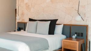 Postel nebo postele na pokoji v ubytování Tago Tulum by G Hotels