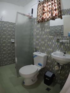 a bathroom with a toilet and a sink at Isla Water Sports and Resorts in Mabini