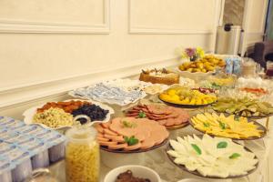 a table with many different types of food on it at Royal Grand Hotel, Turkistan in Türkistan