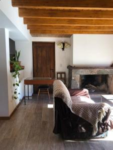 a living room with a table and a fireplace at Casa El Ciprés in Potrerillos
