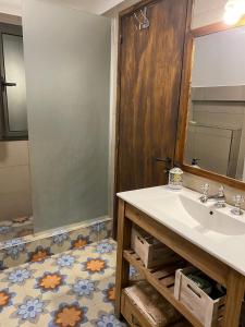 a bathroom with a sink and a mirror at Casa El Ciprés in Potrerillos +36 photos