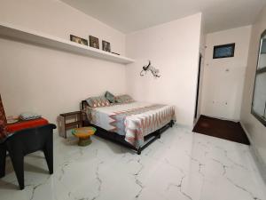 a bedroom with a bed in a room with marble floors at First Man Of Kasar Ram Singh Mehra Homestay in Almora