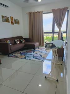 a living room with a couch and a glass table at The clio 2 residences, beside conezion, beside ioi city mall, opposite serdang hospital, beside uniteen and UPM, Putrajaya in Putrajaya