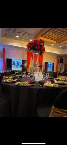 a table with plates of food and a vase of roses at Clarion Pointe Hopkinsville near The Bruce Convention Center in Hopkinsville