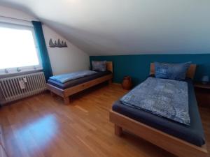 a bedroom with two beds and a window at BodenSEE Apartment Langenargen Möwenweg in Langenargen