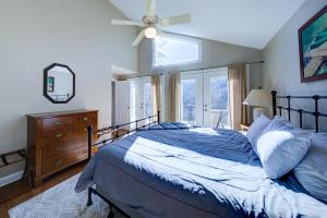 a bedroom with a bed and a ceiling fan at Lakeside Retreat on Lake Rabun in Lakemont