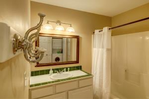 a bathroom with a sink and a mirror and a shower at Lakeside Retreat on Lake Rabun in Lakemont +33 photos