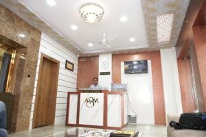 a man standing behind a podium in a room at Hotel Al Sharif Manzil 90 Mtrs from Dargah in Ajmer