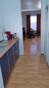 a kitchen with a counter top and a wooden floor at Apart Sudenburg / Magdeburg in Magdeburg