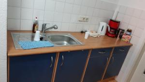 a kitchen counter with a sink in a kitchen at Apart Sudenburg / Magdeburg in Magdeburg