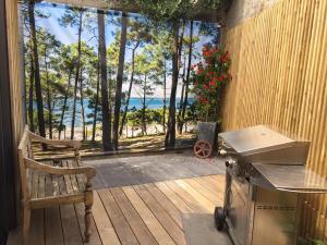 a patio with a grill and a view of the ocean at La Villa Sanson in Arcachon