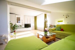uma sala de estar com duas camas e um sofá em Garden Apartments Janša em Radovljica