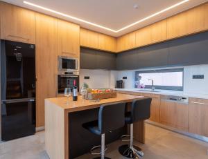 a kitchen with a wooden island with a counter top at Ligaria Mare in Agia Pelagia