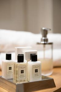 a tray with four bottles of soap on a table at Ligaria Mare in Agia Pelagia