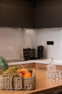 a basket of fruit on a table in a kitchen at Ligaria Mare in Agia Pelagia