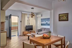 a living room with a couch and a table at Al Centro Pigadia-Althea Homes in Karpathos Town