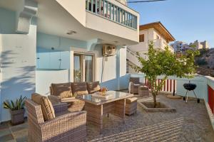 a patio with couches and a table on a building at Al Centro Pigadia-Althea Homes in Karpathos Town