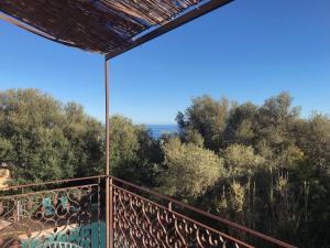 a view of the ocean from the balcony of a house at Chambre Rose in Bastia