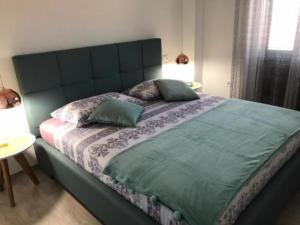 a bed with two pillows on it in a bedroom at Apartments Paloc in Bol