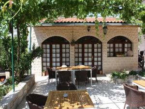 an outdoor patio with a table and chairs at Apartments Paloc in Bol