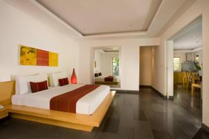 a bedroom with a large bed and a living room at Bali Island Villas & Spa CHSE Certified in Seminyak