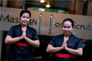 two women standing with their hands in front of a sign at Bali Island Villas and Spa Seminyak in Seminyak +93 photos