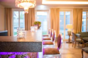 a dining room with a long table and chairs at Hotel Schloss Leitheim in Leitheim