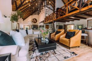 a living room with couches and a table at Karongwe Portfolio - Kuname Lodge in Hoedspruit