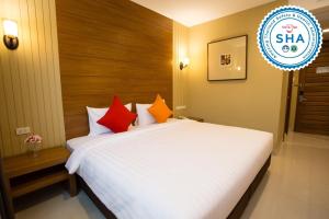 a hotel room with a white bed and white walls at S Bangkok Hotel, Navamin in Ban Khi Sua