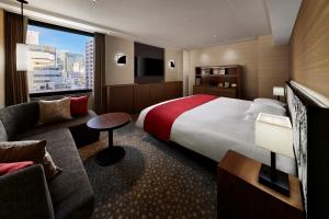 a hotel room with a large bed and a couch at Shiba Park Hotel in Tokyo