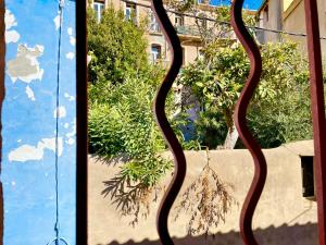 a view of a window with a metal grate at Grand studio sur la Marine in Sète