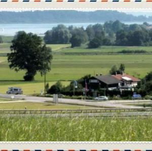a house in the middle of a field with a road at Campingplatz Mariengrund in Bernau am Chiemsee