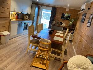 a kitchen and dining room with a table and chairs at Sunde panorama in Olden