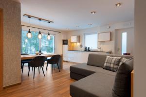 a living room and kitchen with a couch and a table at Apartment Cësa Zinch in Ortisei