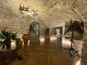 Cette chambre est dotée d'un mur en pierre et d'un plafond avec une tête de cerf sur le mur. dans l'établissement Casa Altemir, à Campo