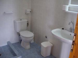 a bathroom with a toilet and a sink at Ourania Sea Breath in Punta