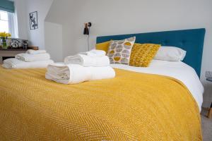 a bedroom with a large bed with towels on it at The Coffee Loft in Padstow