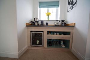 a living room with a fireplace and a window at The Coffee Loft in Padstow