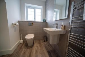 a bathroom with a sink and a toilet and a mirror at The Coffee Loft in Padstow