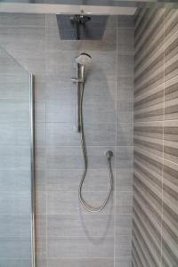 a shower with a shower head in a bathroom at The Coffee Loft in Padstow