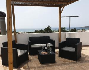 a patio with two chairs and a table with a view of the ocean at APARTAMENTO BOLONIA SUR B in Tarifa