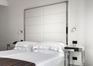 a bedroom with two beds and a large mirror at LHP Napoli Palace & SPA in Naples