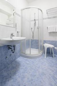 a bathroom with a sink and a shower at Atlas Hotel in Riccione