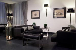 a living room with two couches and a table at LHP Napoli Palace & SPA in Naples